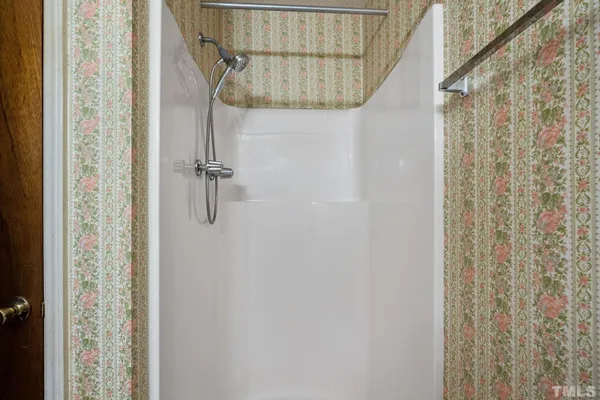 a bathroom with a shower curtain and a window