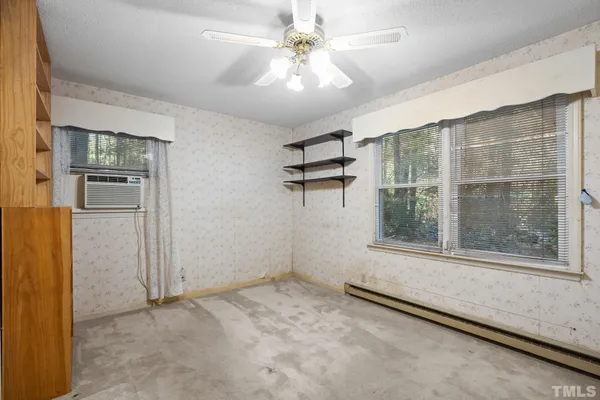 an empty room with windows and entrance