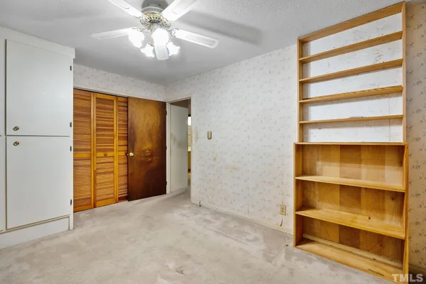 a view of an empty room with a chandelier