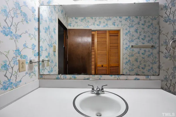 a bathroom with a sink and a mirror