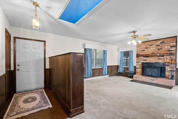 a view of a livingroom with a fireplace and window
