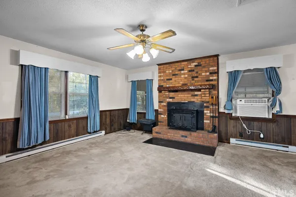 a living room with fireplace and a fireplace