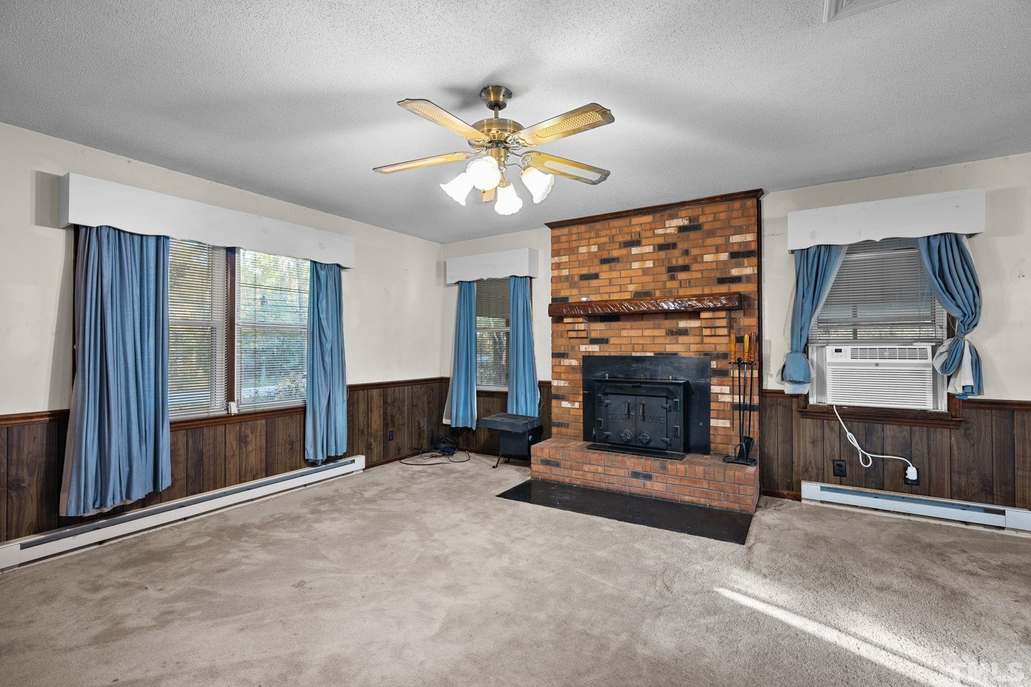 5930 Guess Road Durham, NC 27712 - Photo 6 of 43 a living room with fireplace and a fireplace