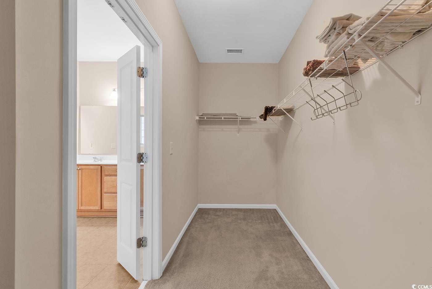 1612 Fairforest Court Conway, SC 29526 - Photo 22 of 40 Walk in closet featuring light carpet