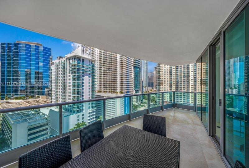 1331 Brickell Bay Drive, Unit 1602 Miami, FL 33131 - Photo 11 of 44 a living room with furniture and a floor to ceiling window