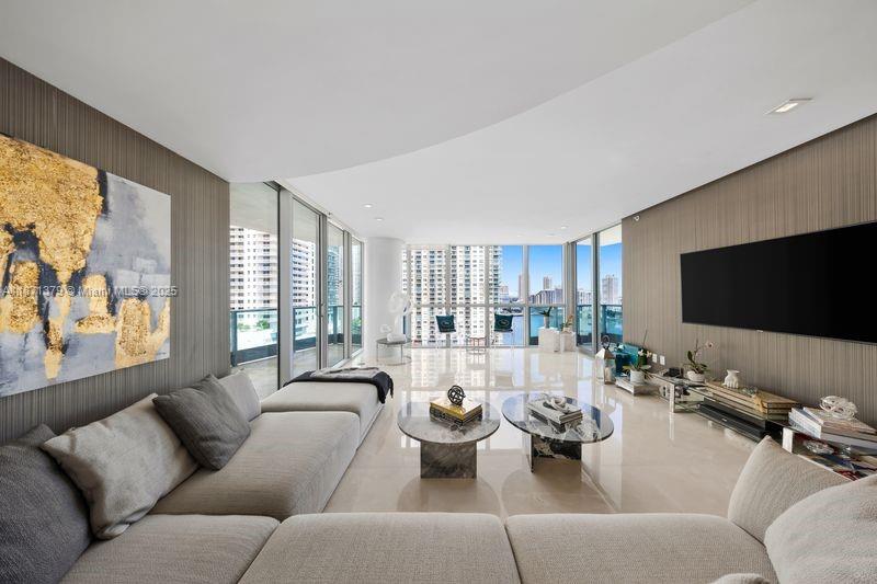 1331 Brickell Bay Drive, Unit 1602 Miami, FL 33131 - Photo 12 of 44 a living room with furniture and a flat screen tv