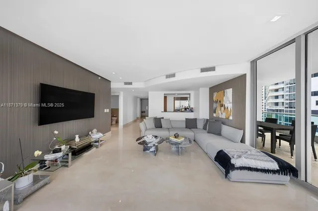 a living room with furniture large window and a flat screen tv