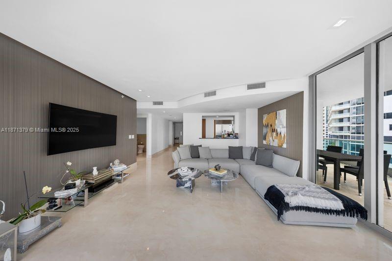 1331 Brickell Bay Drive, Unit 1602 Miami, FL 33131 - Photo 16 of 44 a living room with furniture and a flat screen tv