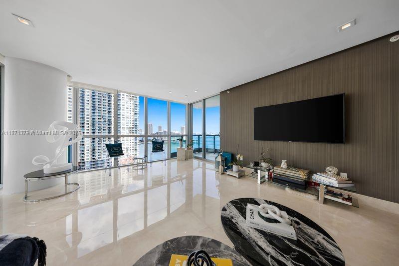 1331 Brickell Bay Drive, Unit 1602 Miami, FL 33131 - Photo 17 of 44 a living room with furniture and a flat screen tv