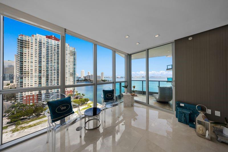 1331 Brickell Bay Drive, Unit 1602 Miami, FL 33131 - Photo 22 of 44 a living room with fireplace furniture and a floor to ceiling window