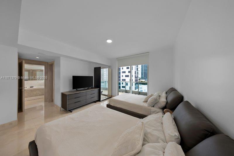 1331 Brickell Bay Drive, Unit 1602 Miami, FL 33131 - Photo 32 of 44 a bedroom with a bed and a flat screen tv