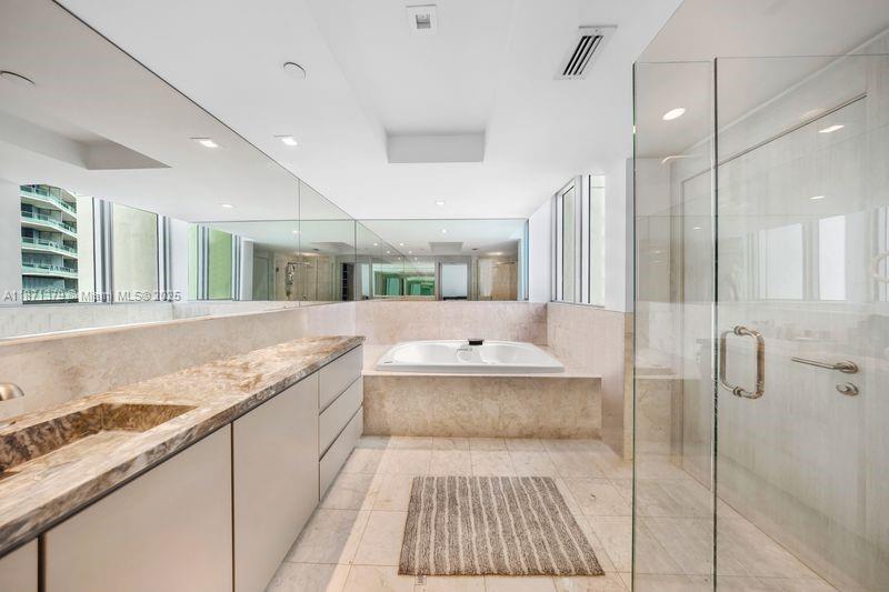 1331 Brickell Bay Drive, Unit 1602 Miami, FL 33131 - Photo 34 of 44 a bathroom with a granite countertop sink a toilet and shower