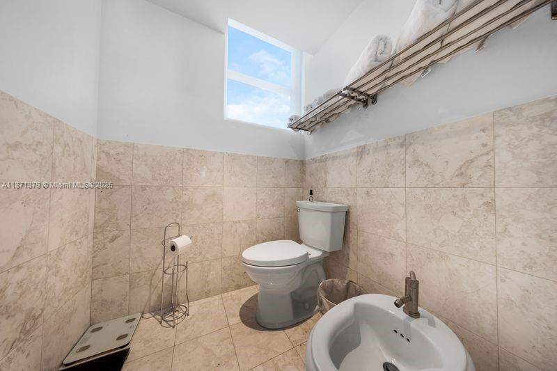 1331 Brickell Bay Drive, Unit 1602 Miami, FL 33131 - Photo 36 of 44 a bathroom with a toilet sink and mirror