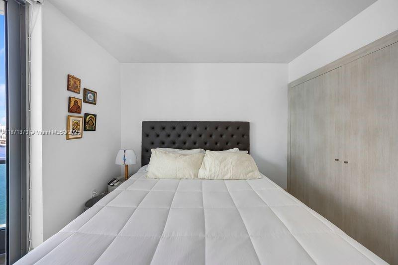 1331 Brickell Bay Drive, Unit 1602 Miami, FL 33131 - Photo 38 of 44 a bedroom with a bed and painting on the wall