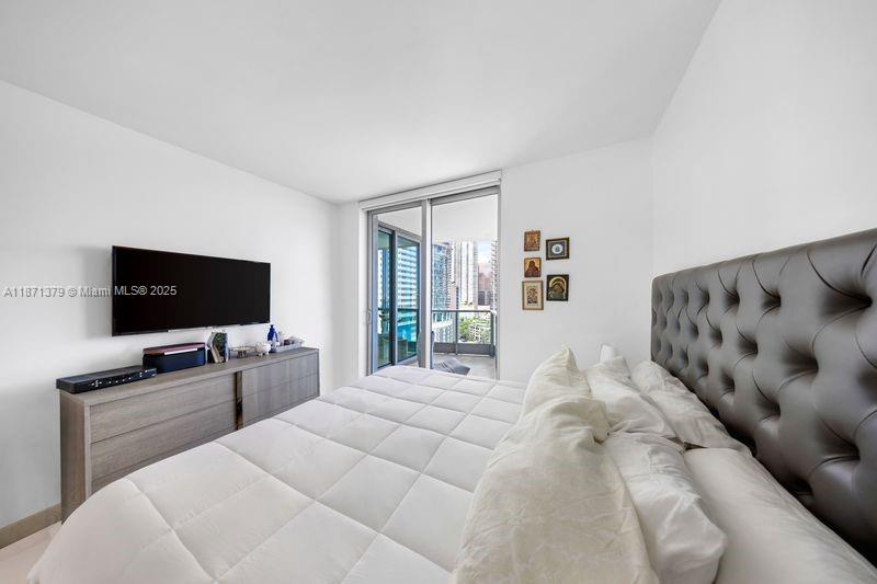 1331 Brickell Bay Drive, Unit 1602 Miami, FL 33131 - Photo 39 of 44 a bedroom with a bed and a flat screen tv