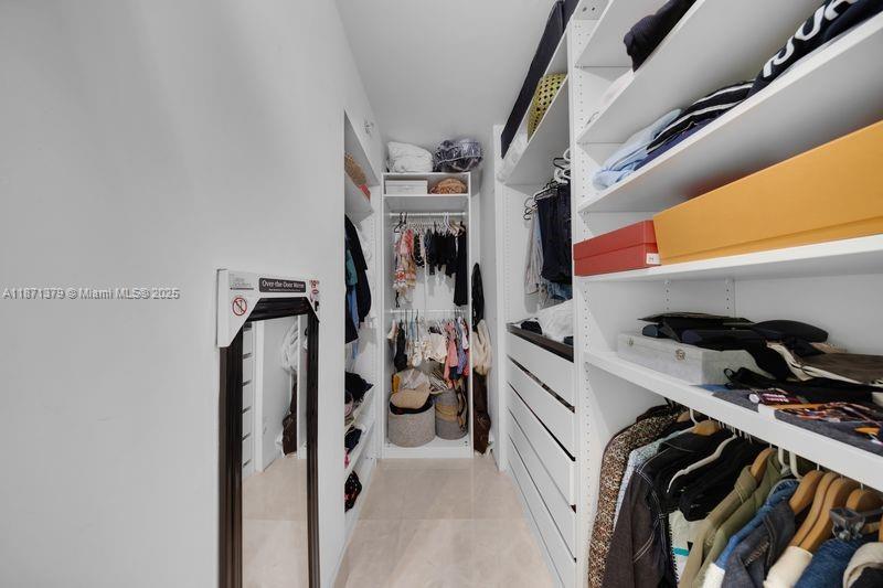 1331 Brickell Bay Drive, Unit 1602 Miami, FL 33131 - Photo 43 of 44 a view of walk in closet with clothes and shoes
