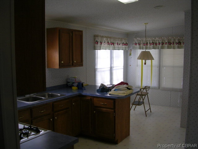1239 Tabernacle Road Mathews, VA 23109 - Photo 21 of 22 a kitchen with a sink cabinets and window