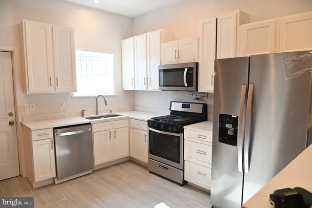 a view of a hallway with wooden floor and entryway