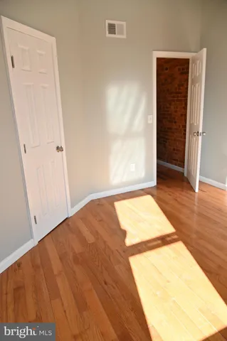 a view of a room with wooden floor