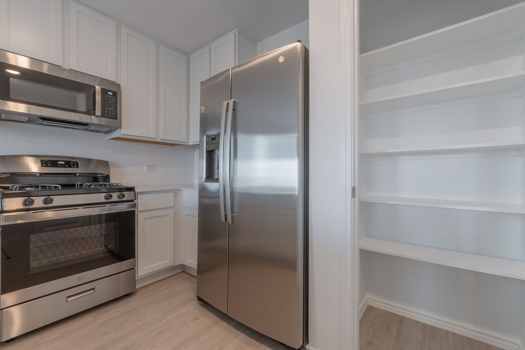 216 Little Sparklers Loop Hutto, TX 78634 - Photo 10 of 39 a metallic refrigerator freezer sitting in a kitchen