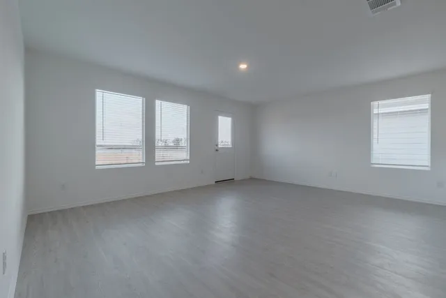 a metallic refrigerator freezer sitting in a kitchen