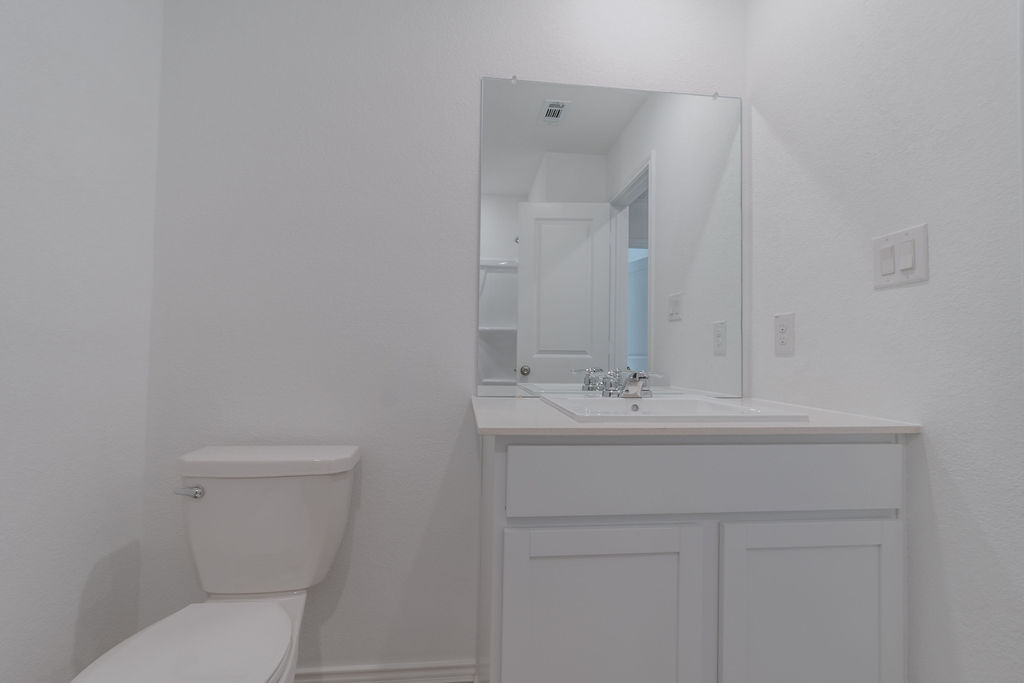 216 Little Sparklers Loop Hutto, TX 78634 - Photo 18 of 39 a bathroom with a sink a toilet and mirror