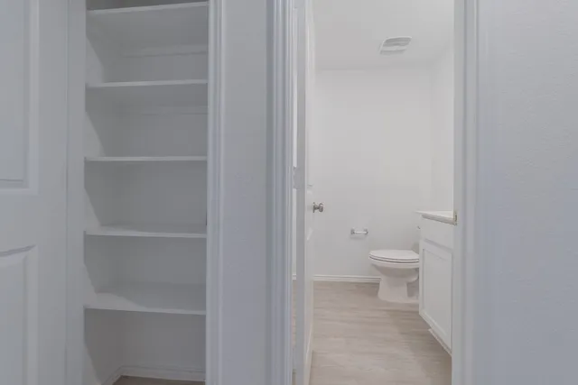 a bathroom with a sink a toilet and mirror
