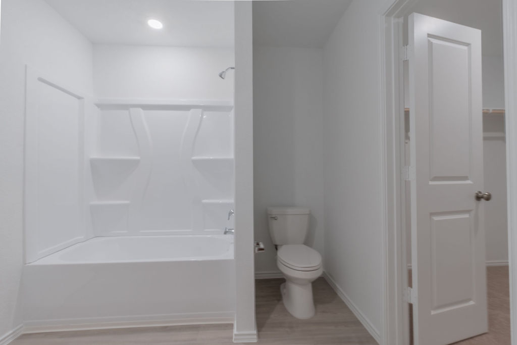 216 Little Sparklers Loop Hutto, TX 78634 - Photo 32 of 39 a bathroom with a toilet and a bathtub