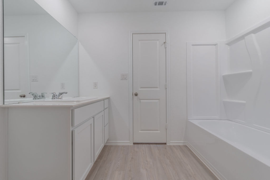 216 Little Sparklers Loop Hutto, TX 78634 - Photo 33 of 39 a bathroom with a sink a mirror and a bathtub