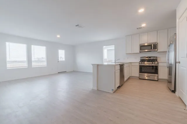 a view of a kitchen with a sink and a microwave