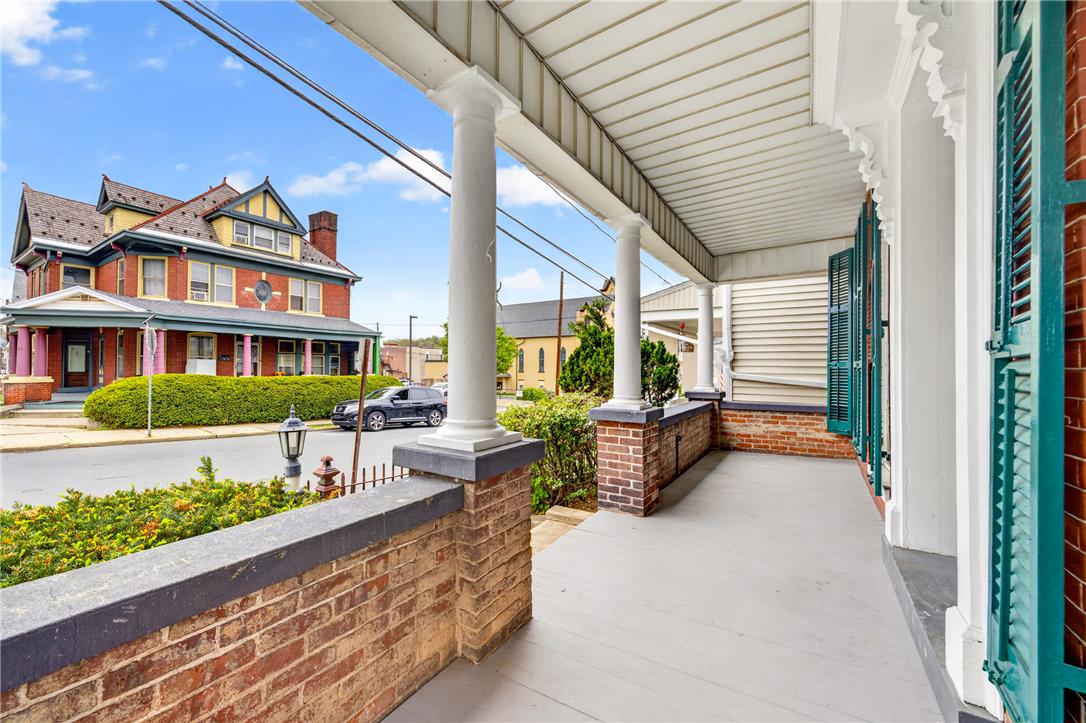 65 2nd Street Slatington, PA 18080 - Photo 6 of 46 Relax on this inviting covered front porch, offering charming street views and a classic brick facade.