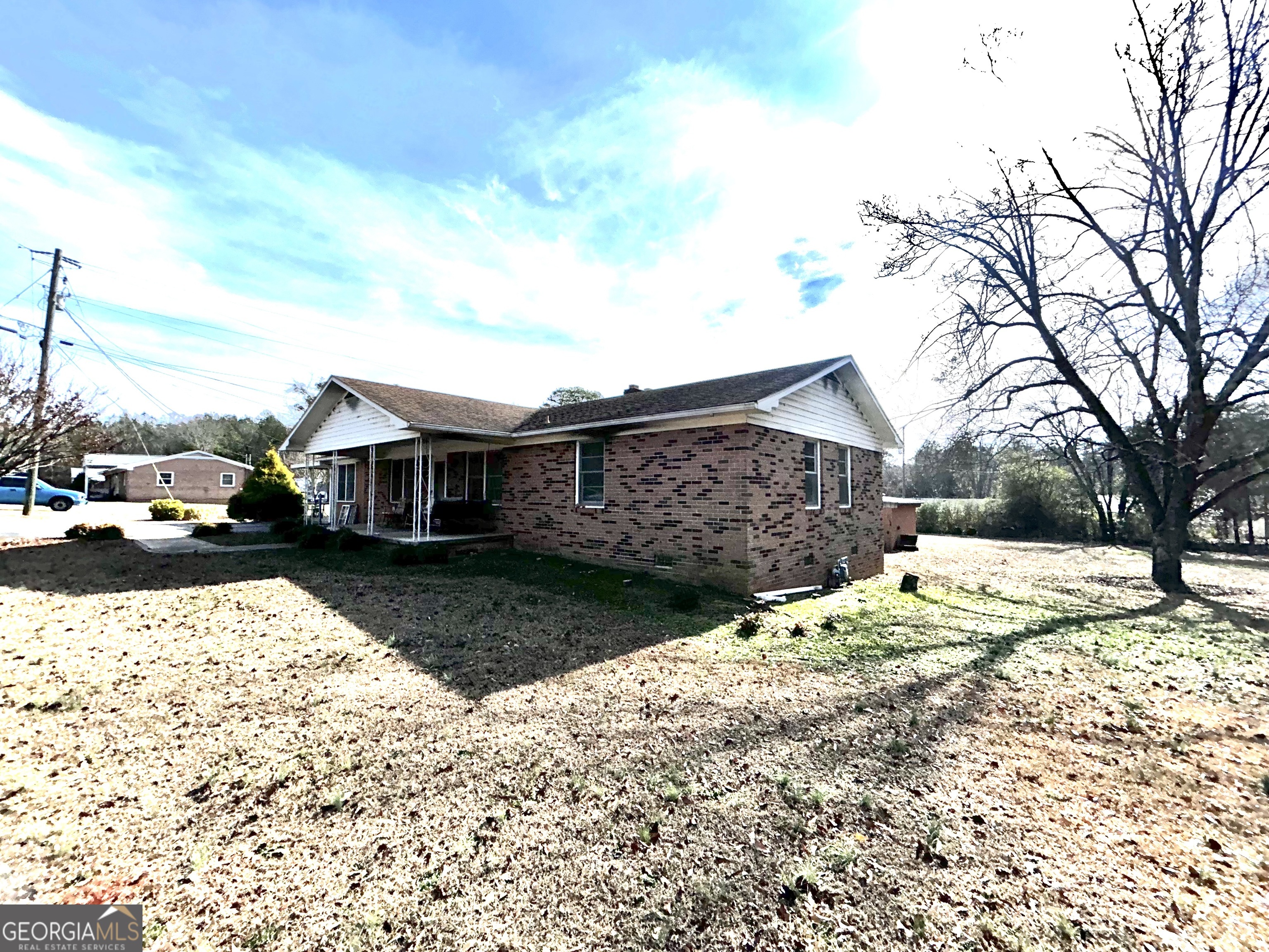 a front view of a house with a yard covered with snow