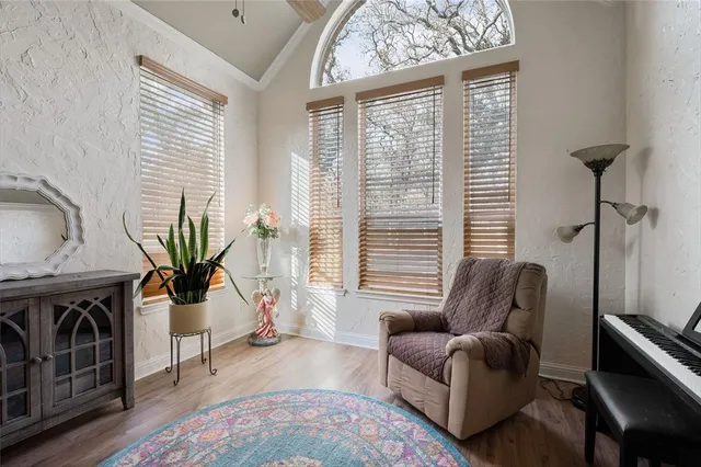 a living room with furniture a fireplace and a floor to ceiling window