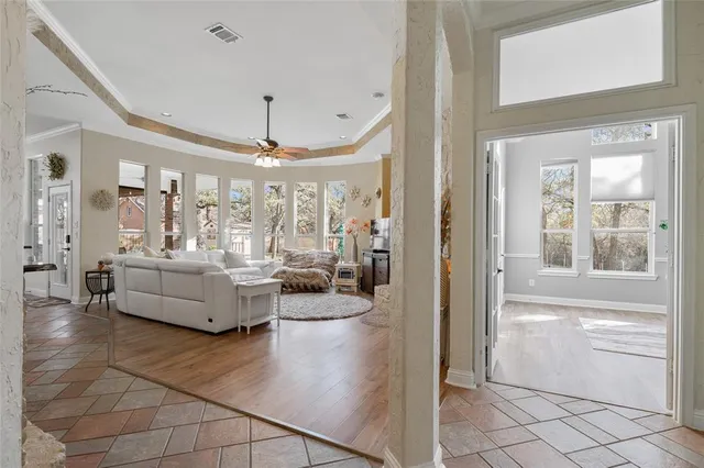 a living room with furniture and a chandelier