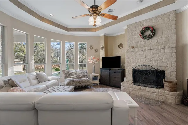 a living room with furniture a fireplace and a flat screen tv