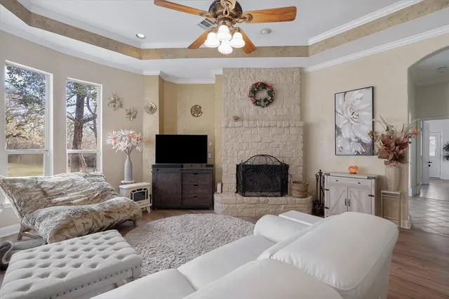 a bedroom with furniture a flat screen tv and a fireplace