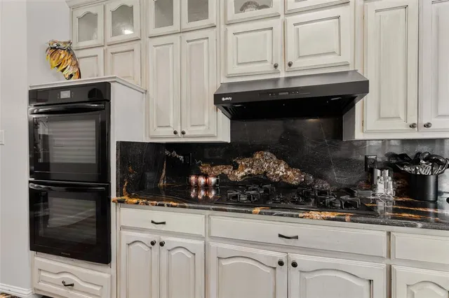 a kitchen with a stove and cabinets