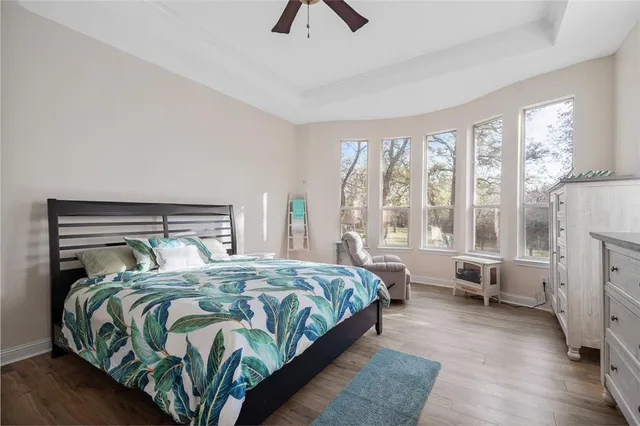 a bedroom with a bed a couch and a large window