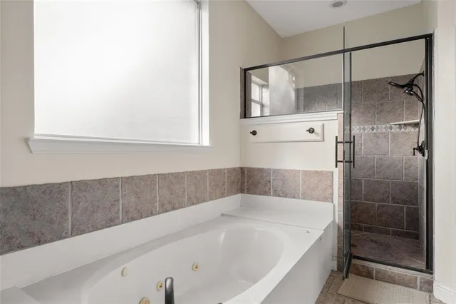 a bathroom with a bathtub and a shower