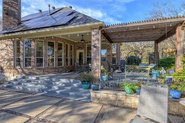 a view of a patio with a table and chairs under an umbrella