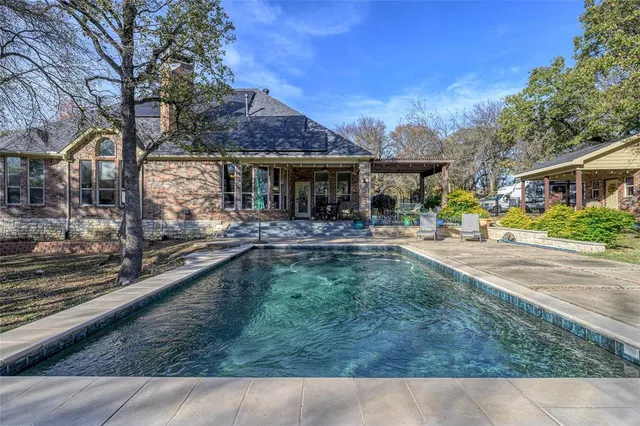 a swimming pool view with a outdoor seating