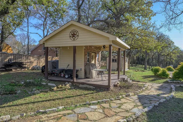 a view of a chair and table in backyard of the house