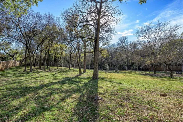 a view of field with trees in the background