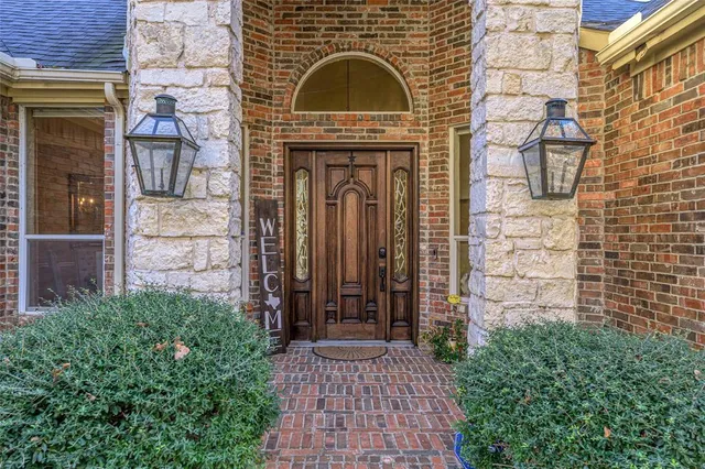 a view of a door of a house with potted plants