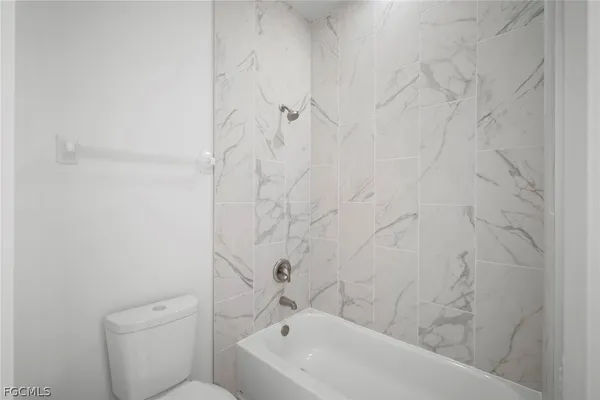 a bathroom with a bathtub and toilet