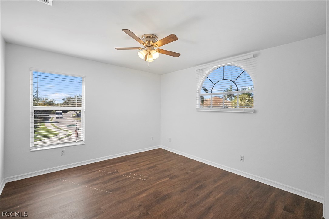 21768 Brixham Run Loop Estero, FL 33928 - Photo 20 of 36 a view of empty room with wooden floor and window