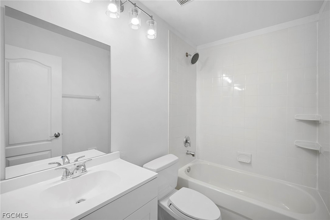 21768 Brixham Run Loop Estero, FL 33928 - Photo 23 of 36 a bathroom with a bathtub shower sink vanity mirror and toilet