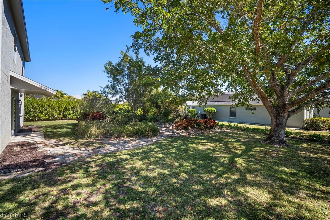 21768 Brixham Run Loop Estero, FL 33928 - Photo 34 of 36 a view of a tree in a yard