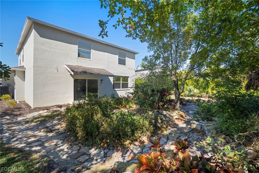 21768 Brixham Run Loop Estero, FL 33928 - Photo 35 of 36 a view of a house with a tree
