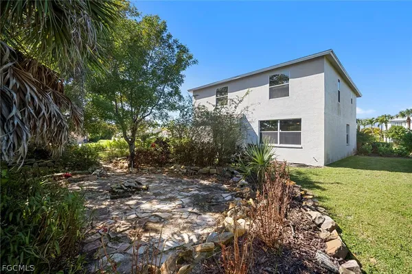 a backyard of a house with a tree